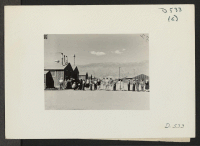 [recto] Manzanar, Calif.--Ready to pass into dining room at Manzanar, a War Relocation Authority center for evacuees of Japanese ancestry. ;  Photographer: Stewart, Francis ;  Manzanar, California.