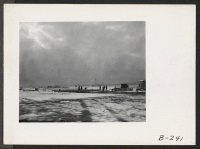 [recto] A wintry view of early construction work on the Tule Lake schools. All work is being done by evacuees of Japanese ancestry. ;  Photographer: Stewart, Francis ;  Newell, California.