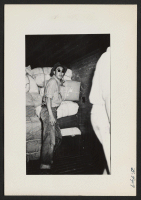 [recto] Tom Matsumoto, a segregee, to a large extent directed the transfer of checkable baggages shown supervising the loading of one baggage car. He was sent to Tule Lake on September 25 train. ;  Photographer: Lynn, Charles R. ;  Dermott, Arkansas.