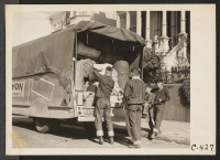 [recto] San Francisco, Calif. (2031 Bush Street)--Boys of Japanese ancestry unloading bed rolls and baggage, which they have brought from their homes to the WCCA station, awaiting evacuation to an assembly center. ;  Photographer: Lange, Dorothea ;  San Franc