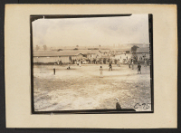 [recto] Arcadia, Calif.--An impromptu baseball game in held by young evacuees of Japanese descent at Santa Anita assembly center. ;  Photographer: Albers, Clem ;  Arcadia, California.