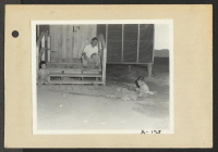 [recto] Poston, Ariz.--(Site No. 1) Mosaru Oshio with his children on the steps of his barrack home at this War Relocation Authority center for evacuees of Japanese ancestry. ;  Photographer: Clark, Fred ;  Poston, Arizona.