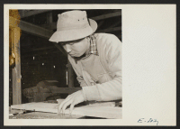 [recto] A young former Californian of Japanese ancestry, now residing in the Jerome Relocation Center, operates a joiner in the center cabinet shop. ;  Photographer: Parker, Tom ;  Denson, Arkansas.