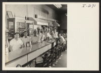 [recto] Bill Mori, owner of the K & J Restaurant, 88 E. Main St., Waterbury, Connecticut, operates a successful business in the center of the city. Mr. Mori lines his workers up for the photographer, with himself at the head. ;  Photographer: Iwasaki, Hikaru