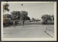[recto] All available trucks were made ready for transporting evacuees from Tule Lake arriving at Granada. ;  Photographer: McClelland, Joe ;  Amache, Colorado.