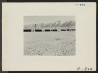 [recto] Manzanar, Calif.--View of barrack homes at this War Relocation Authority center, showing outside entrances. ;  Photographer: Lange, Dorothea ;  Manzanar, California.