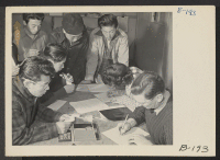 [recto] A view in the block manager's office, where evacuees signed up for indefinite leave registration clearance. ;  Photographer: Stewart, Francis ;  Manzanar, California.
