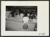 [recto] New Year's Fair. A kitchen in the fair area served pie and tea to visitors to this New Year event. ;  Photographer: Stewart, Francis ;  Poston, Arizona.