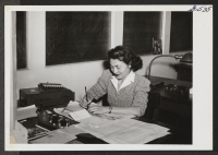 [recto] Miss Mary Nojima, Jerome, discussing bookkeeping details with her boss, Miss Bassett, in the Payroll Department of the Farm Journal, Philadelphia. Miss Bassett says that Miss Nojima is her invaluable aide. ;  Philadelphia, Pennsylvania.