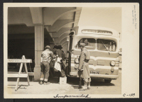 [recto] A Greyhound bus bringing evacuees to the assembly center. ;  Photographer: Lange, Dorothea ;  San Bruno, California.