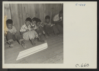 [recto] Manzanar, Calif.--An elementary school with voluntary attendance has been established with volunteer evacuee teachers, most of whom are college graduates. These young evacuees are eager to learn and do not mind the lack of equipment. ;  Photographer: La