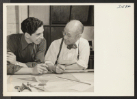 [recto] Mr. Soichi Yamamoto, formerly of Pasadena, California, and Gila River, is shown here with a fellow employee doing mechanical design ...