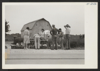 [recto] Choice cantaloupes are grown on the Missouri River bottom land. Many of the farmers prefer to sell direct to the consumers as here shown west of St. Louis, where workers from a nearby ordnance plant stop to purchase the melons. ;  Photographer: Mace, Ch