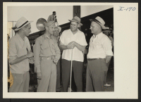 [recto] Closing of the Jerome Center, Denson, Arkansas. Left to right: R. A. Walling, Transportation Supervisor, W.R.A., San Francisco; Major C. L. Whitmarsh; W. O. Melton and E. B. Whitaker on hand to supervise the loading of the train for Gila River. ;  Photo