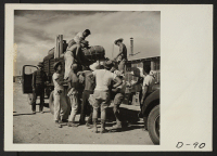 [recto] Eden, Idaho--Baggage belonging to evacuees from the assembly center at Puyallup, Washington, is sorted and trucked to owners in their barrack apartments. ;  Photographer: Stewart, Francis ;  Hunt, Idaho.