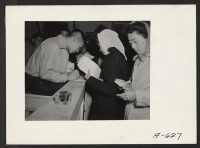 [recto] Absentee voters of Japanese descent getting ballots and having them notarized. ;  Photographer: Stewart, Francis ;  Newell, California.