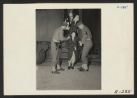 [recto] Lone Pine, Calif.--Soldiers assist elderly evacuee of Japanese descent leave car steps on transfer to War Relocation Authority center at Manzanar. ;  Photographer: Albers, Clem ;  Lone Pine, California.