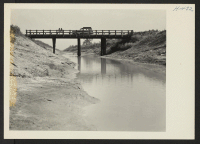 [recto] Closing of the Jerome Center, Denson, Arkansas. Main bridge, No. 1, over ditch No. 1, which helps drain a Jerome agricultural area. The bridge was built by the evacuees. ;  Photographer: Mace, Charles E. ;  Denson, Arkansas.