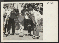 [recto] No discrimination in this huddle. Akshi Alan Asakora (center) plays football in the yard of the Lincoln School in Santa ...