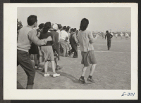 [recto] The crowd breaks the line during a tense moment of a football game between Stockton and Santa Anita teams. ;  Photographer: Parker, Tom ;  McGehee, Arkansas.