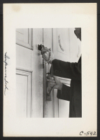 [recto] Hands of Rev. Naito (Buddhist) are here shown as he locks the door of his church. The beads are carried by Buddhist priests at all times. ;  Photographer: Lange, Dorothea ;  Florin, California.