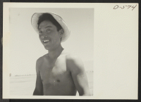 [recto] A young Nisei who assisted in sowing onions in the field at this relocation center. ;  Photographer: Stewart, Francis ;  Manzanar, California.