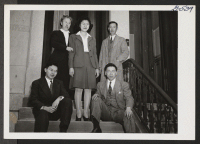 [recto] The Inouye Family, Jerome, on the steps of the Philadelphia Hostel. Mr. and Mrs. S. Inouye, as managers of the Hostel, stand ready to welcome all newcomers while Miyoko, William, and George are enthusiastic aides on weekends from nearby Swarthmore College