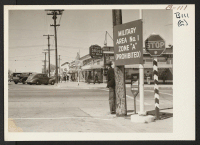 [recto] Sign on main street designating military zone. ;  Photographer: Albers, Clem ;  Lancaster, California.