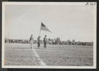 [recto] Presentation of colors before start of football game between Topaz High School and Millard County High School of Fillmore at Topaz Relocation Center on Armistice Day, November 11, 1943. ;  Topaz, Utah.
