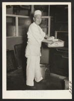 [recto] Shizuo (Jimmie) Mitsuhata, chef at Clifton's Cafeteria in Los Angeles, on the job after having returned from Manzanar on May ...