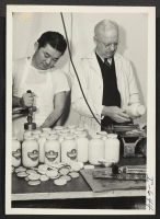 [recto] Francis Ichikawa and W. H. Bishop, the proprietor of Clark's Salad Dressing Company, are shown getting the cap bottles ready ...