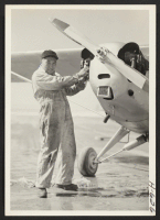 [recto] Hershel Abe, former resident of the Jerome, Arkansas, relocation center, works on a plane at the Pueblo, Colorado, municipal airport. ...