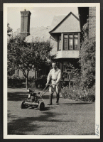 [recto] Mr. Toshichi Mitoma is shown operating a power lawn mower in the rear of the Thomas Dougherty home in Cleveland, ...