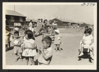 [recto] A kindergarten class at the Tule Lake Center on the playground. ;  Photographer: Bigelow, John ;  Newell, California.
