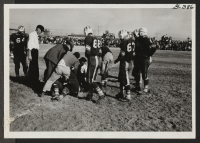 [recto] Casualty in the ranks of Topaz football team during game with Fillmore High School at Topaz Relocation Center November 11, 1943. ;  Topaz, Utah.