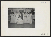 [recto] The Labor Day queen and her attendants are shown at the coronation ceremony which was held as a part of the celebration at this relocation center. ;  Photographer: Stewart, Francis ;  Newell, California.