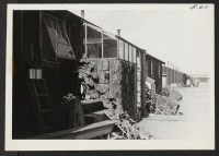 [recto] Original stoop built at entrance to evacuee apartment. ;  Photographer: Cook, John D. ;  Newell, California.