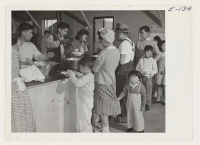 [recto] Dinner is served cafeteria style to young and old in the mess halls at the Heart Mountain Relocation Center. ;  Photographer: Parker, Tom ;  Heart Mountain, Wyoming.