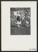 [recto] A fashion show was one of the many exhibits held at this relocation center on Labor Day. Great skill was shown in dressmaking and tailoring, and was thoroughly appreciated by the large audience which witnessed this display. ;  Photographer: Stewart, Fra