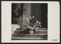 [recto] Arranging flowers for altar on last day of services at Japanese Independent Congregational Church, prior to evacuation. Evacuees of Japanese ancestry will be housed in the War Relocation Authority centers for the duration. ;  Photographer: Lange, Doroth