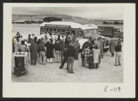[recto] Heart Mountain residents of Japanese ancestry come to the aid of Wyoming and Montana beet growers as one group of the 1700 volunteers board a bus for Montana farms. ;  Photographer: Parker, Tom ;  Heart Mountain, Wyoming.