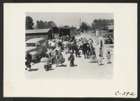 [recto] Turlock, Calif.--Families of Japanese ancestry arriving at the Turlock Assembly Center. Their baggage will be inspected for contraband and they ...