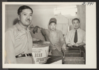 [recto] Left to right: Ben Oishi, Larry Fujii and Ben Furuta. Mr. Furuta, formerly from Colorado River, is shown with two of his assistants in the shipping department of the Bean Sprout Company at Duluth, Minnesota. ;  Duluth, Minnesota.