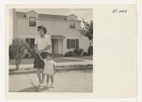 [recto] Mrs. Saiki Yamaguchi is shown with her daughter Susan, age 2, at the Tanaka home, 38 Colorado Street, San Mateo. ...