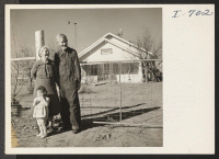 [recto] Mr. and Mrs. C. S. Inman and their granddaughter in front of the Inman farm home. Mr. Inman was the first farmer in the Deaf Smith County area to offer a lease of share-cropping deal to an evacuee farmer. ;  Photographer: Iwasaki, Hikaru ;  Hereford,