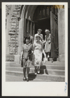 [recto] Evacuees leaving the Central Methodist Church in Detroit after the service they had attended on Sunday, June 20, 1943. Miss ...