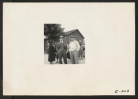 [recto] A Caucasian friend has come to say goodbye to his farmer friends of Japanese ancestry prior to their evacuation to an Assembly Center. ;  Photographer: Lange, Dorothea ;  Centerville, California.