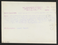 [verso] Identification photos are made of relocation center residents when they apply for indefinite or seasonal leave. The camera, here shown ...