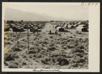 [recto] A view of the Manzanar Relocation Center showing streets and blocks. ;  Photographer: Lange, Dorothea ;  Manzanar, California.