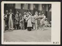 [recto] San Pedro, Calif.--Evacuated residents of Japanese ancestry await transportation to assembly center at Arcadia, California. They will be transferred later to War Relocation Authority centers for the duration. ;  Photographer: Albers, Clem ;  San Pedro